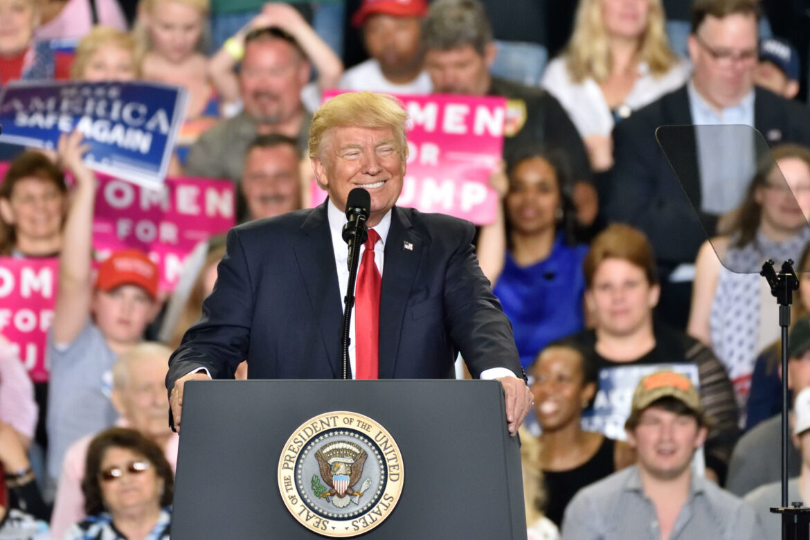 JHE49M President Donald Trump smiles on stage as he delivers a campaign rally speech to mark his "100th day" in office. Held at The Farm Show Complex and Exp
